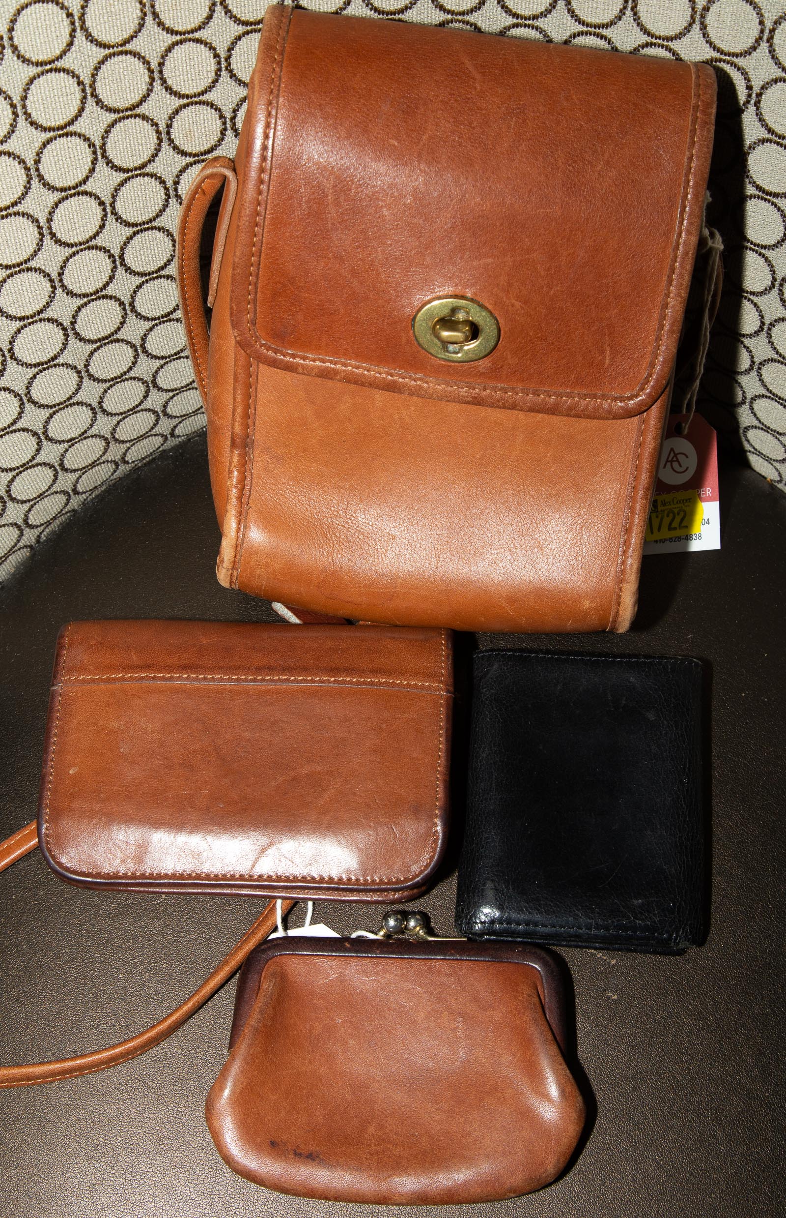 Appraisal: A BROWN LEATHER BAG THREE LEATHER WALLETS A brown leather