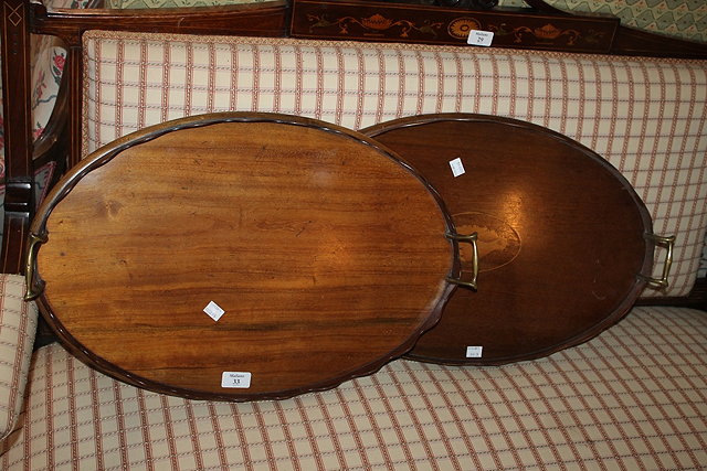 Appraisal: TWO OVAL EDWARDIAN MAHOGANY TRAYS each with brass handles and