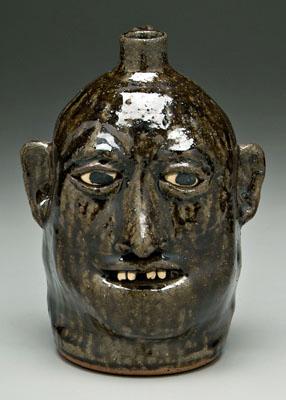 Appraisal: Lanier Meaders stoneware face jug ceramic teeth runny dark olive