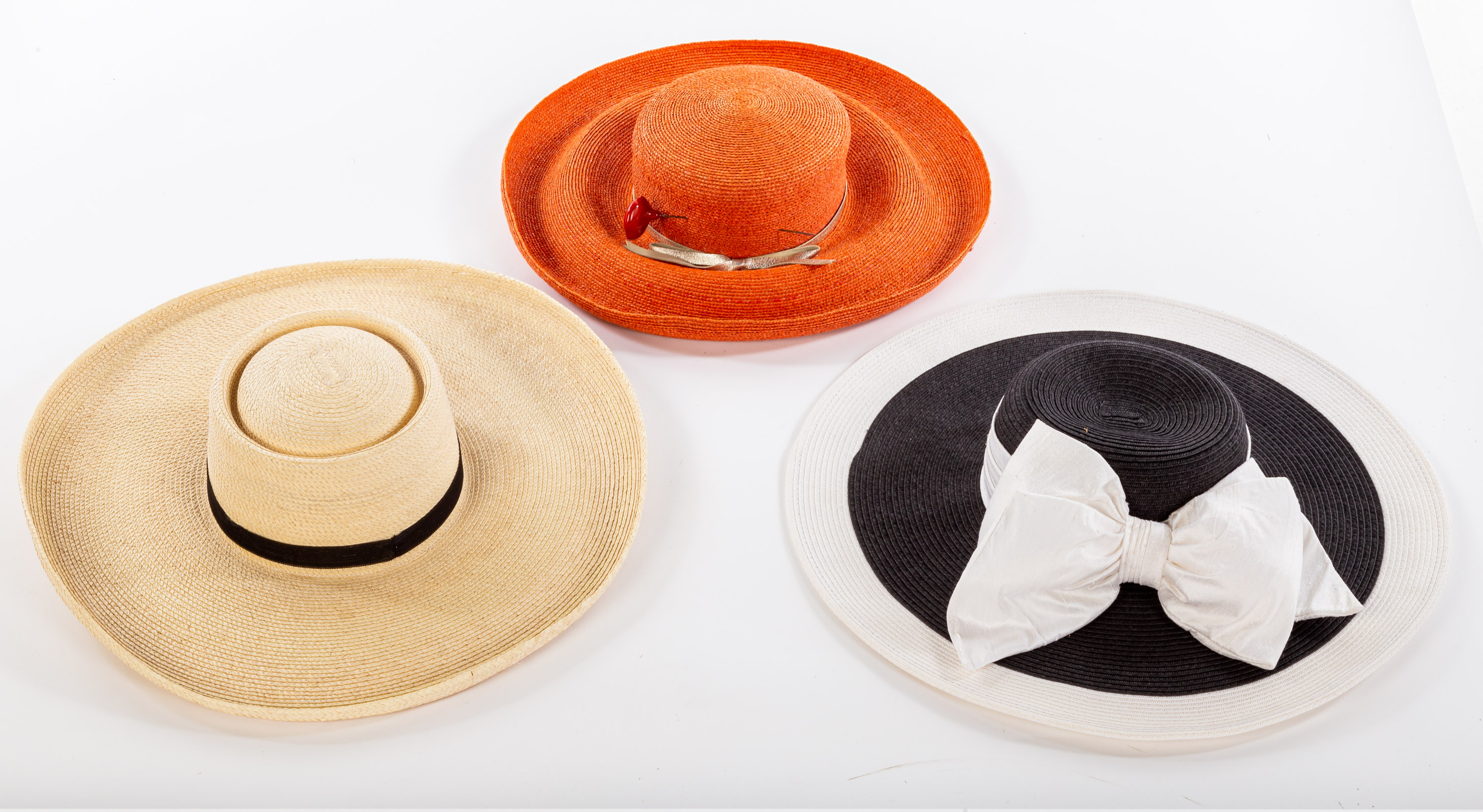 Appraisal: THREE WOVEN STRAW SUN HATS One black and white Toucan