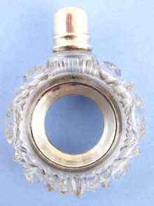 Appraisal: An unusual white metal tests silver combination scent bottle quizzing