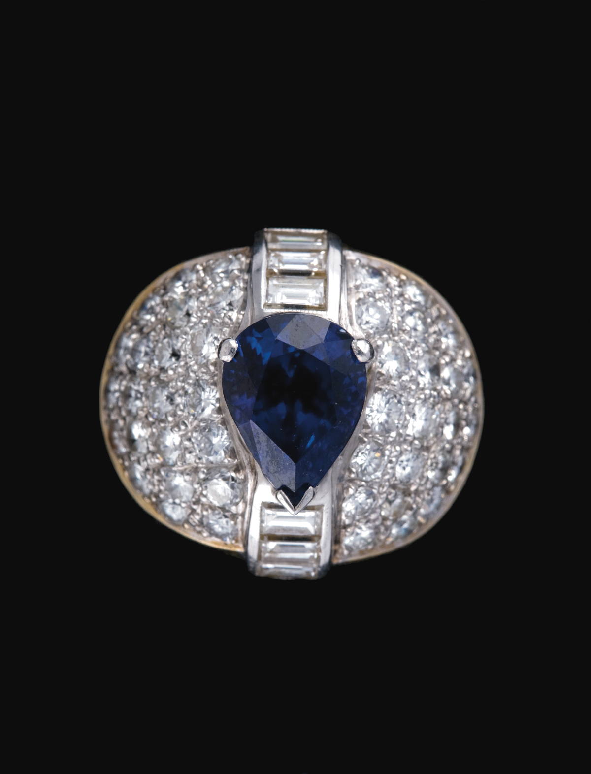 Appraisal: GOLD SAPPHIRE AND DIAMOND RING The pear-shaped sapphire with full