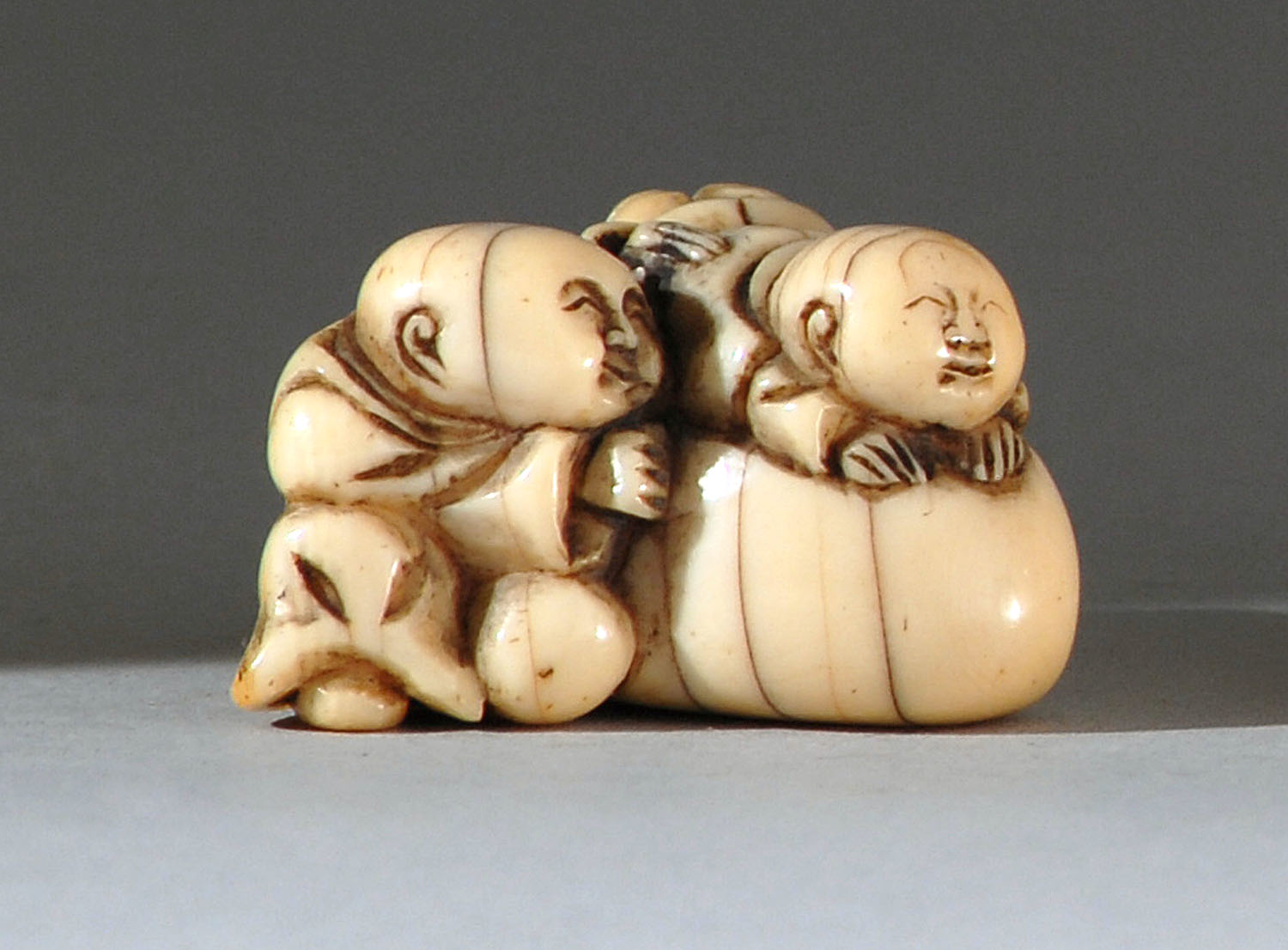 Appraisal: IVORY NETSUKE th CenturyIn the form of two karako playing