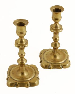 Appraisal: A pair of early George III brass candlesticks with shaped