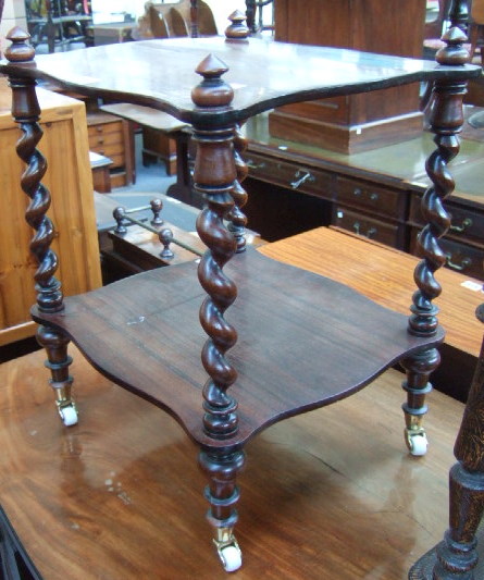 Appraisal: A th century rosewood shaped two tier whatnot the top