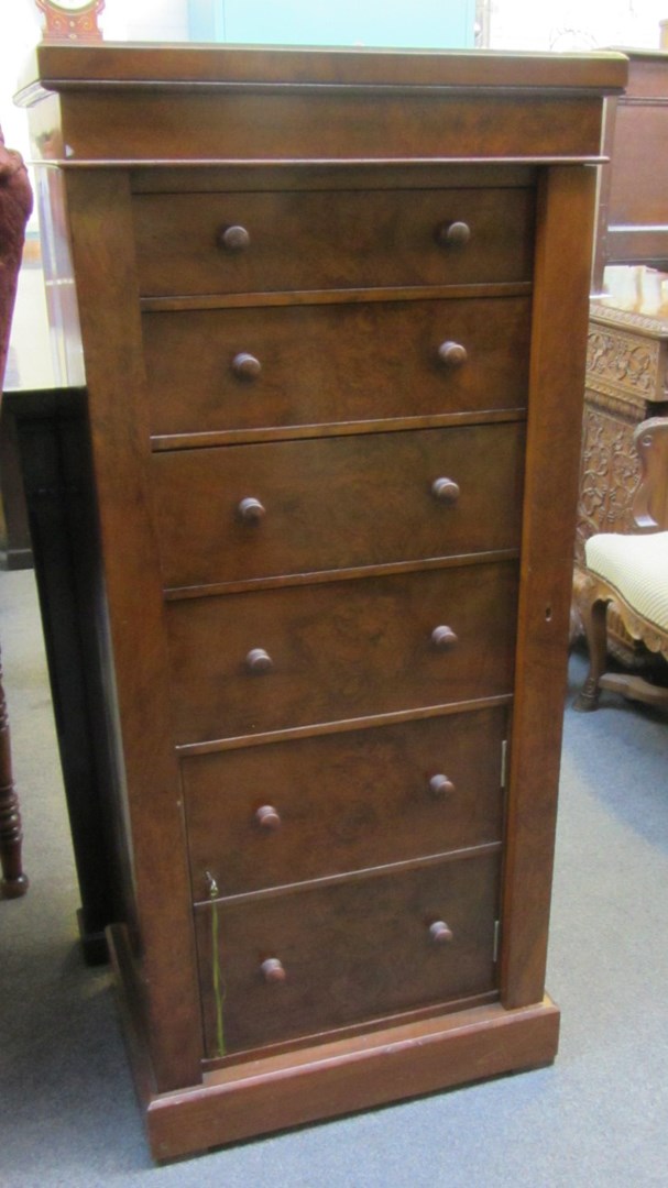 Appraisal: A Victorian walnut Wellington chest the locking bar enclosing four