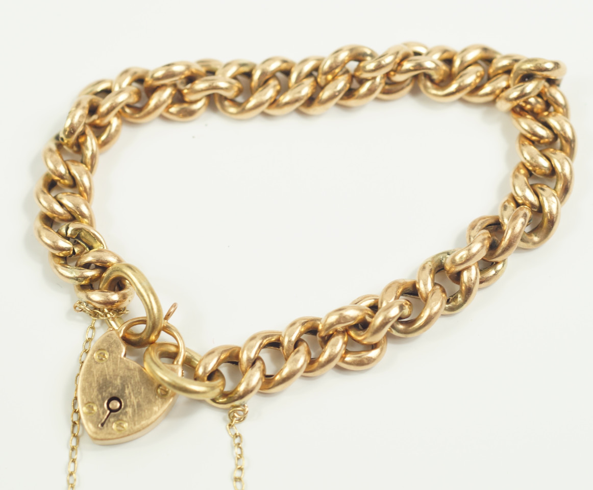 Appraisal: A yellow metal curb link bracelet on a heart shaped