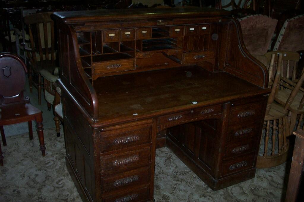 Appraisal: A good Edwardian oak roll top desk the S-shaped tambour