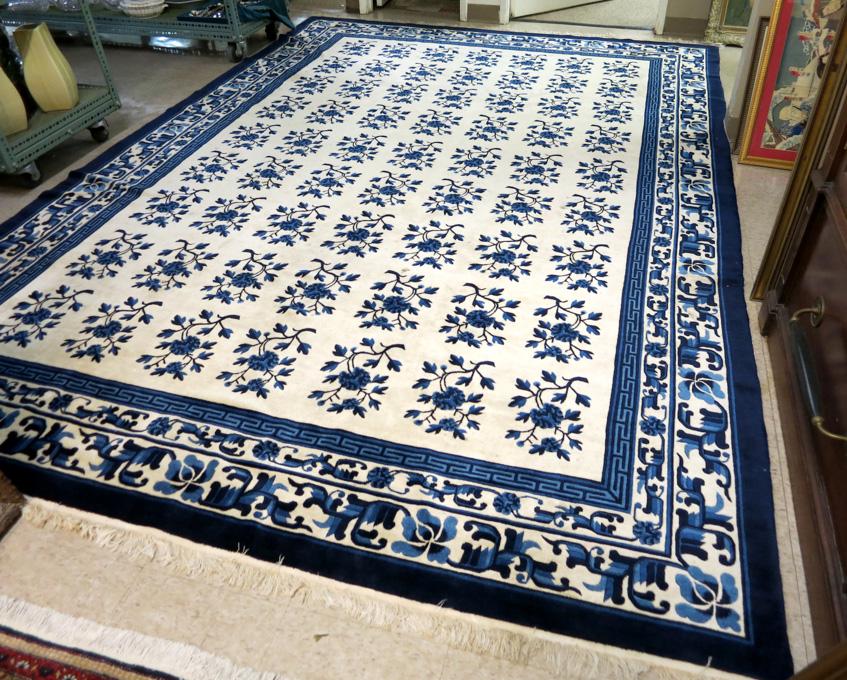 Appraisal: HAND KNOTTED PEKING CARPET featuring repeating columns of -tone blue