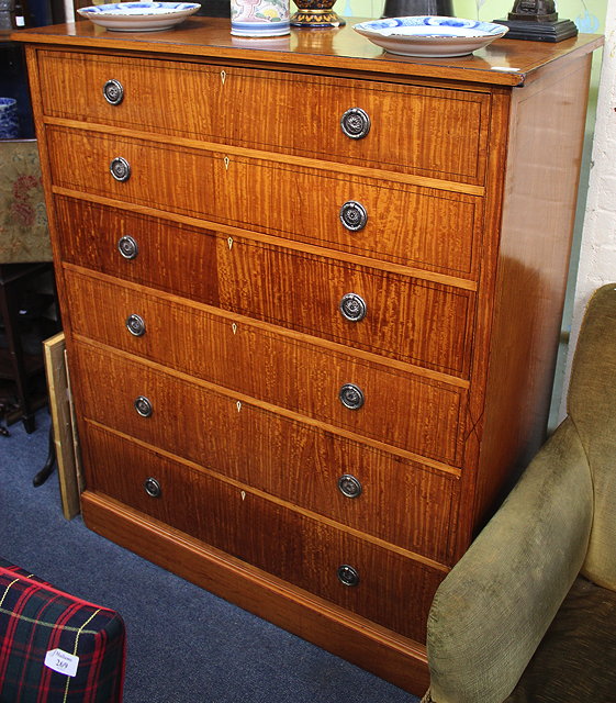 Appraisal: A SATINWOOD CHEST OF SIX LONG GRADUATED DRAWERS with silvered