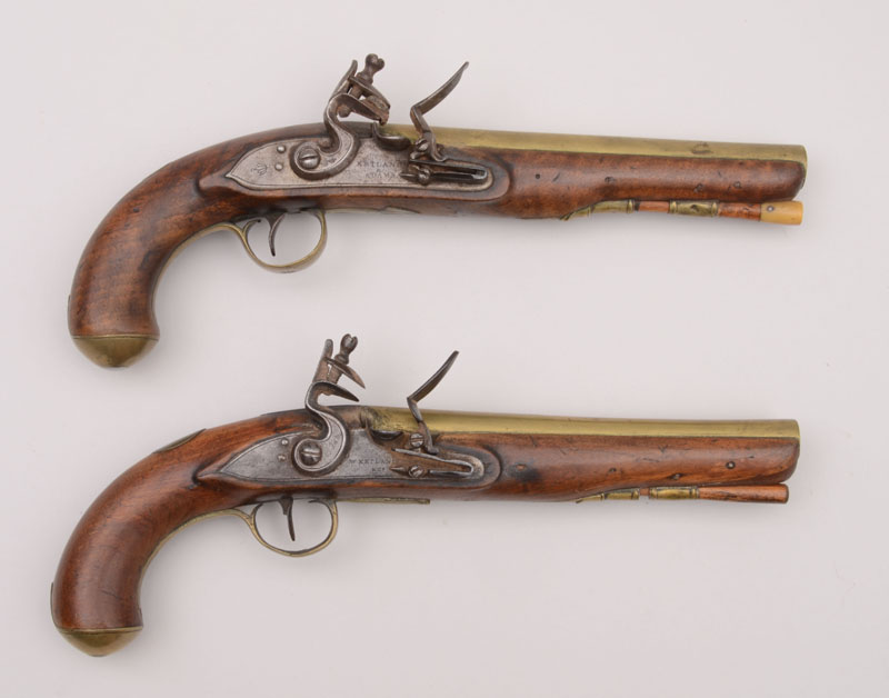 Appraisal: TWO SIMILAR ENGLISH FLINTLOCK PISTOLS Two brass-mounted English flintlock near-pair