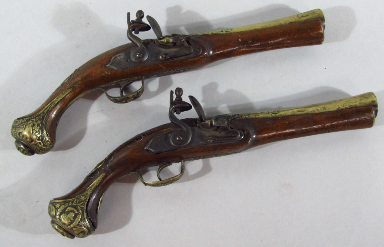 Appraisal: A pair of replica brass and walnut flint lock pistols