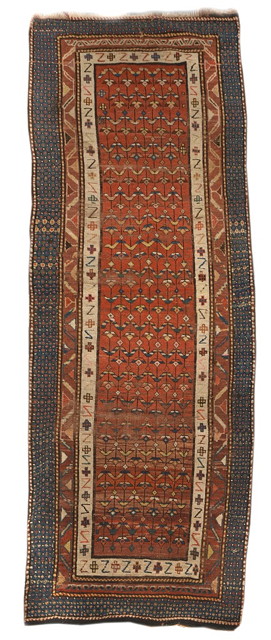 Appraisal: A PERSIAN RUST GROUND RUNNER decorated a central repeating pattern