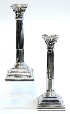 Appraisal: A PAIR OF CANDLESTICKS modelled as Corinthian columns with beaded