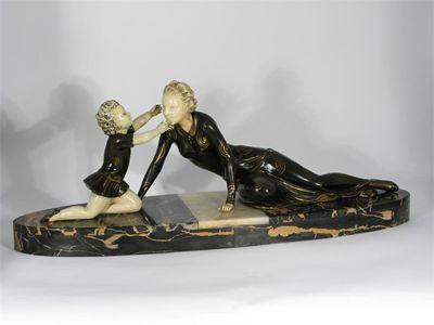 Appraisal: A patinated spelter and ivorine figure of a woman and