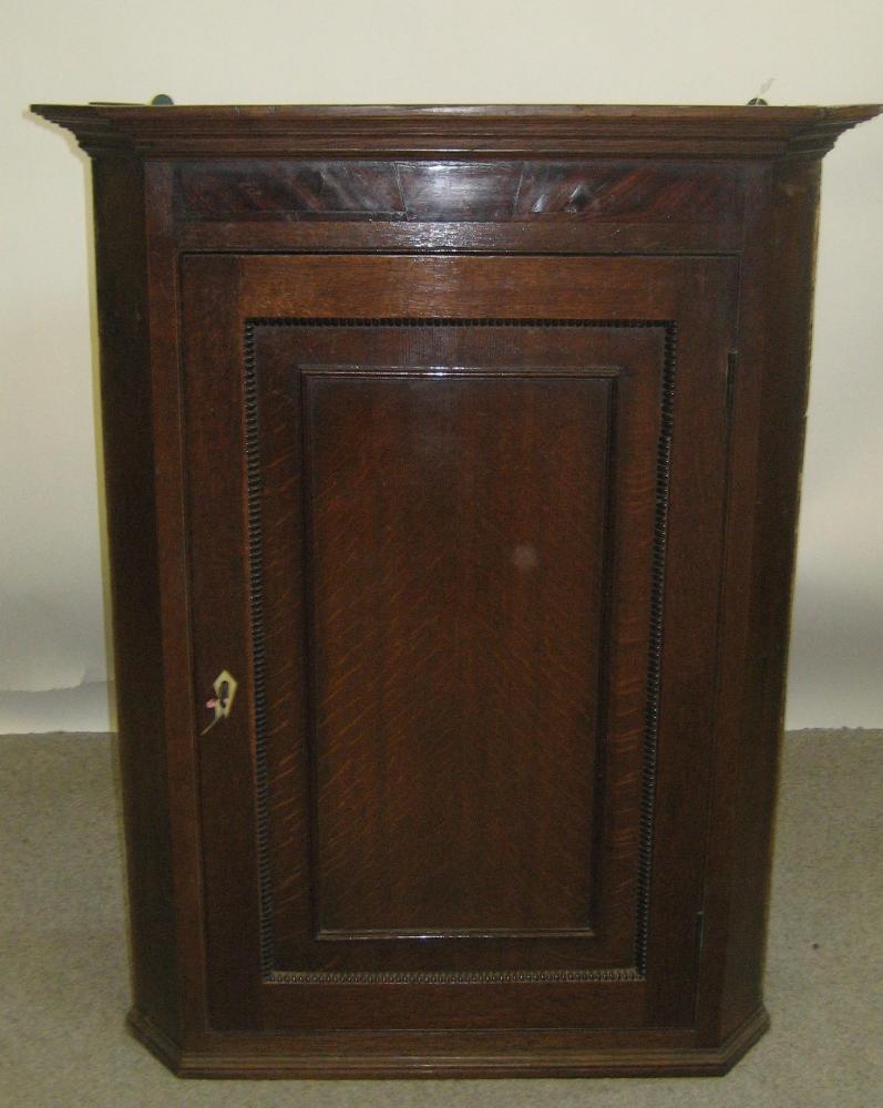 Appraisal: A GEORGE III OAK CORNER CUPBOARD early th century the