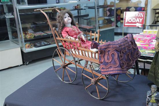 Appraisal: C M BERGMANN GERMAN BISQUE HEAD DOLL AND BUGGY Brunette