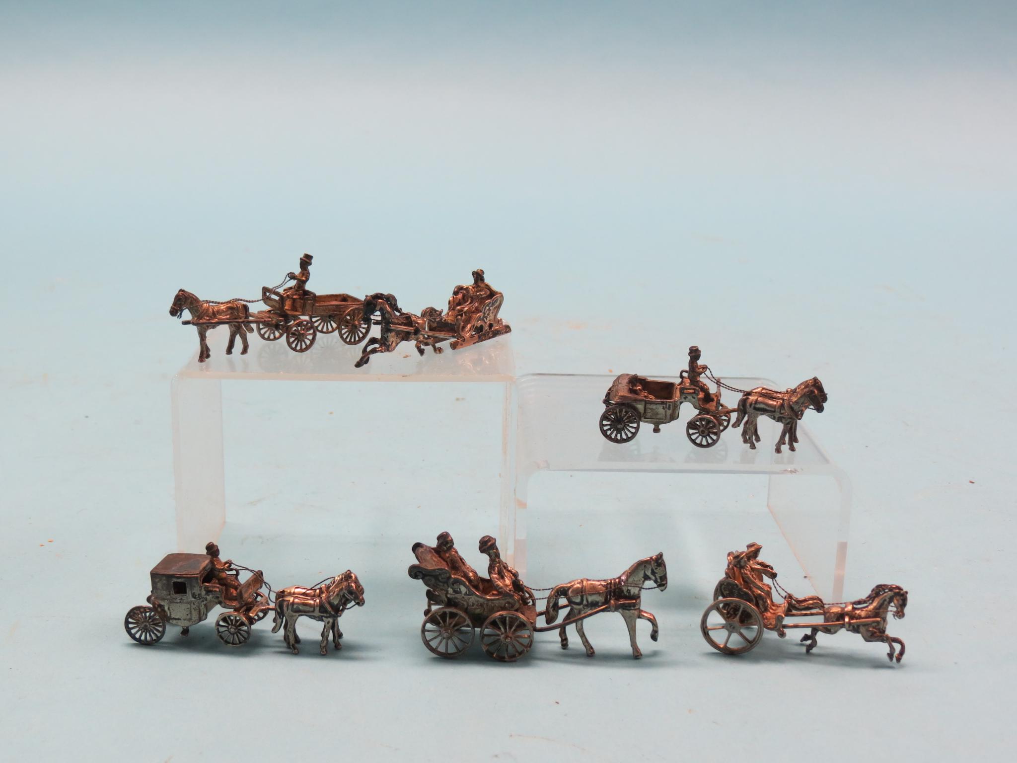 Appraisal: Four imported silver horse and carriage sleigh models and two