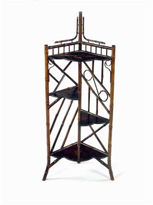 Appraisal: A late Victorian 'bamboo' corner etagere with four shaped Japanned