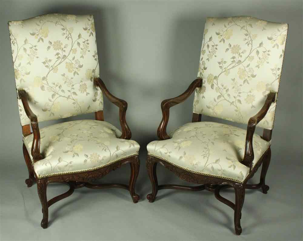 Appraisal: PAIR OF FRENCH REGENCY STYLE WALNUT OPEN ARM LIBRARY CHAIRS