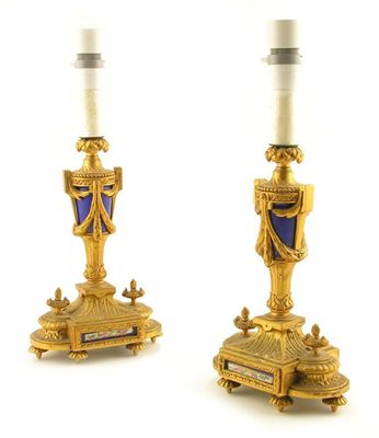 Appraisal: A pair of French gilt metal and porcelain mounted candlesticks