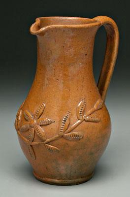 Appraisal: Earthenware pitcher orange and green mottled glaze with applied flowers