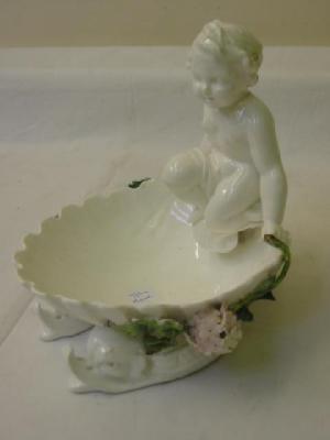 Appraisal: A PORCELAIN FIGURAL DISH modelled as a shell surmounted by