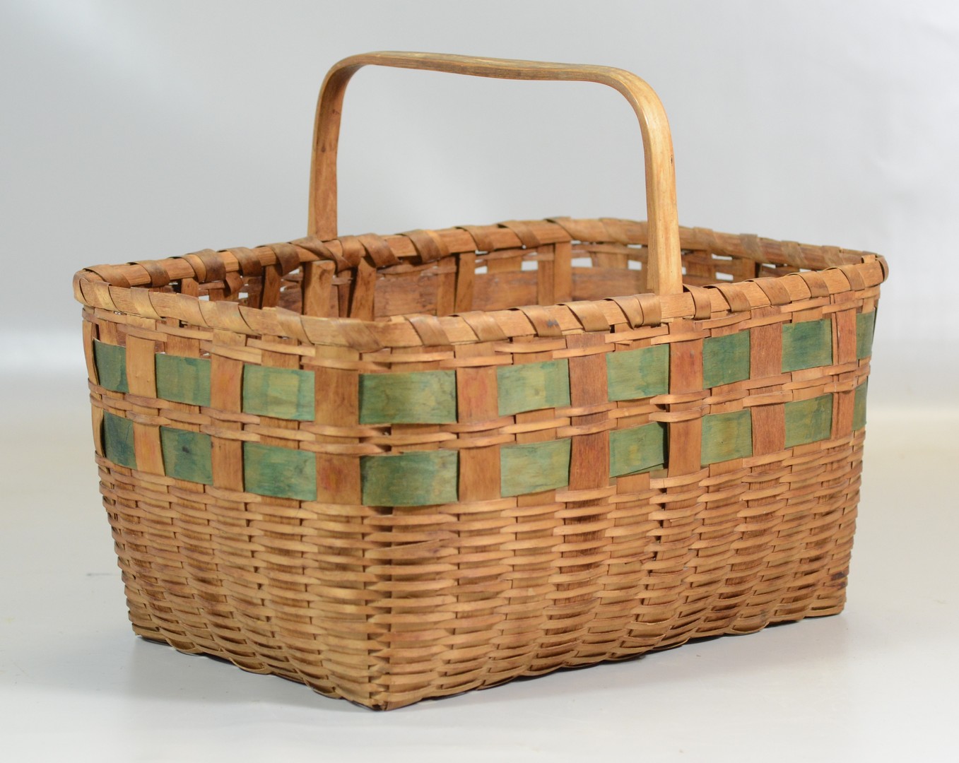 Appraisal: Woven reed gathering basket with rectangular oak bent wood handle