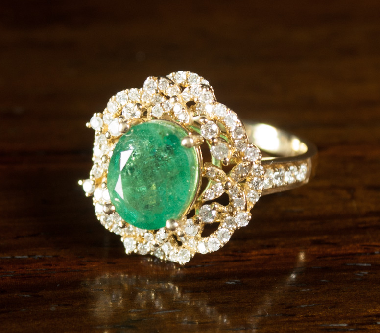 Appraisal: EMERALD DIAMOND AND FOURTEEN KARAT GOLD RING with round-cut diamonds