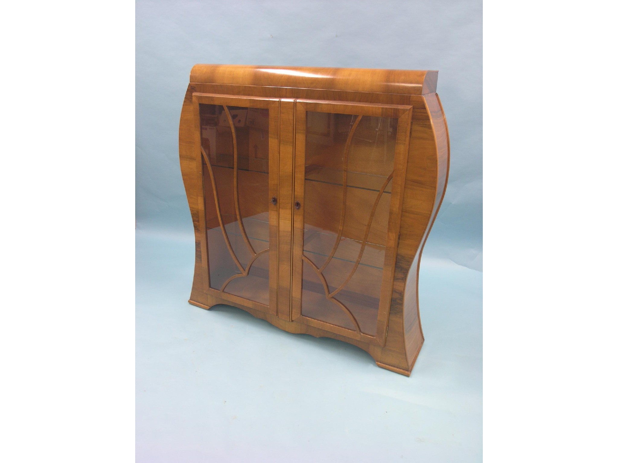 Appraisal: An Art Deco walnut veneered display cabinet pair of glazed