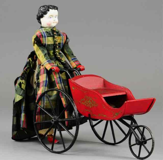 Appraisal: GOODWIN GIRL PUSHING DOLL CARRIAGE Pat incredible action allows girl's