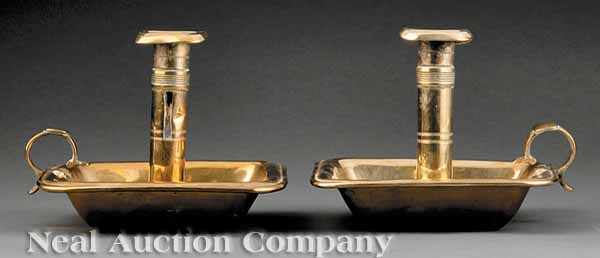 Appraisal: A Pair English Brass Chambersticks th c each with push-up