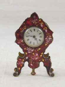 Appraisal: A small French clock with enamel dial the case guilloche