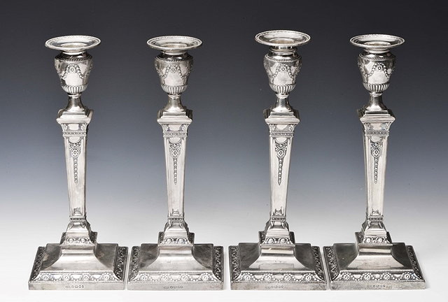 Appraisal: A SET OF FOUR VICTORIAN SILVER CANDLESTICKS with square stepped