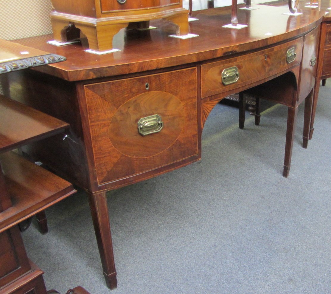 Appraisal: A George III mahogany bowfronted sideboard with a trio of