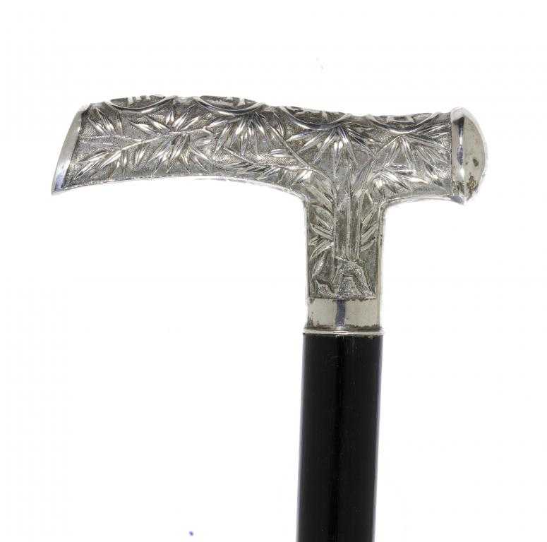 Appraisal: A CHINESE SILVER HANDLED EBONY CANE the repouss tau handle