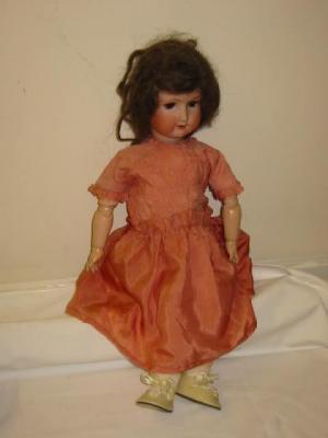 Appraisal: An Ernst Heubach bisque head girl doll with brown glass