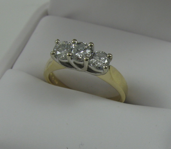 Appraisal: DIAMOND AND FOURTEEN KARAT GOLD RING set with three round-cut