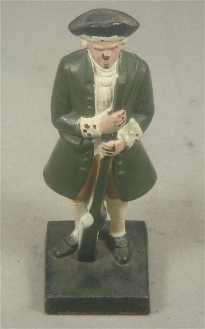 Appraisal: Cast iron doorstop Colonial Officer in full uniform with gun