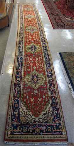 Appraisal: HAND KNOTTED ORIENTAL LONG RUG Indo-Persian repeating geometric medallion and