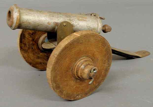 Appraisal: Carved wood and metal working toy cannon with spring load