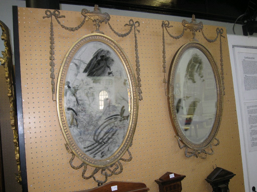 Appraisal: Pair of gilt framed mirrors with urn and swag decoration