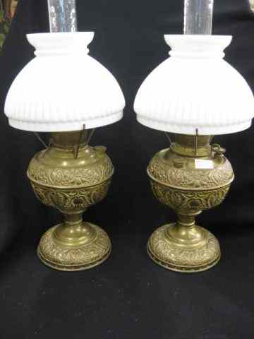 Appraisal: Pair of Victorian Kerosene Lamps ornate brass bases with milkglass