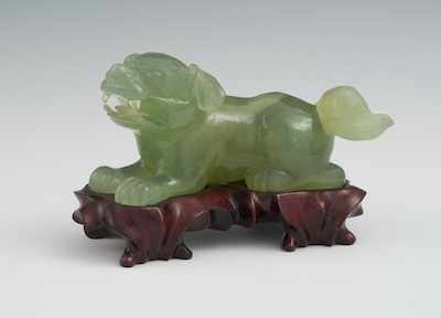 Appraisal: A Carved Spinach Bowenite Hardstone Foo Dog on Carved Rosewood