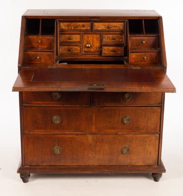 Appraisal: An th Century walnut and feather banded bureau the interior