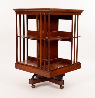 Appraisal: An Edwardian walnut revolving bookcase with slatted sides cm wide