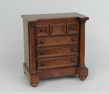 Appraisal: A Miniature Chest of Drawers The miniature Empire style chest