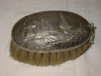 Appraisal: A DUTCH TABLE BRUSH of domed oval form embossed with