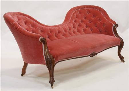 Appraisal: A Victorian mahogany framed button back conversation sofa the double