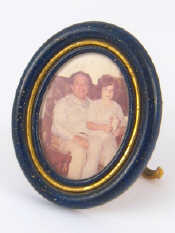 Appraisal: Cartier An oval photo frame with enamelled border two cabochons